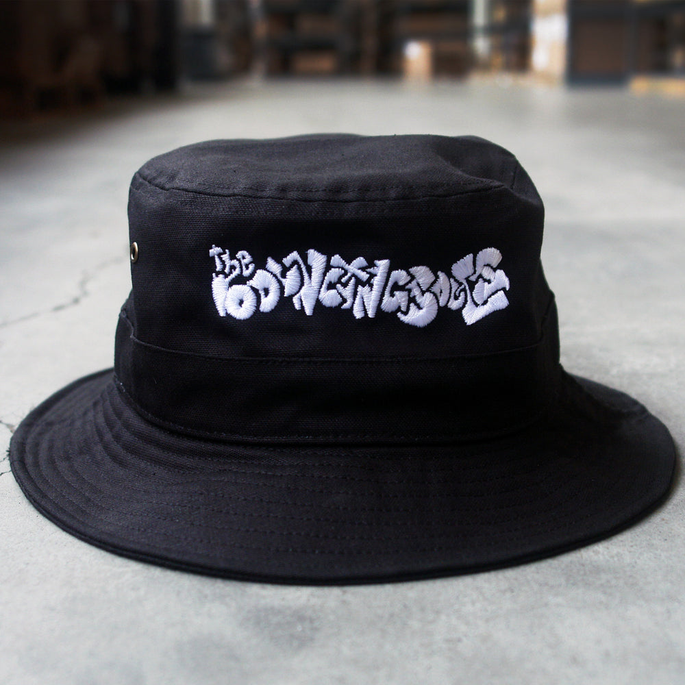 image of a black bucket hat on concrete background. white embroidery on the front in graffiti font that reads the bouncing souls